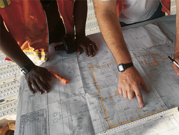 Two engineers assessing commissioning design plans 