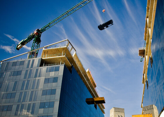 Crane moving 600 ton chillers above a high rise building