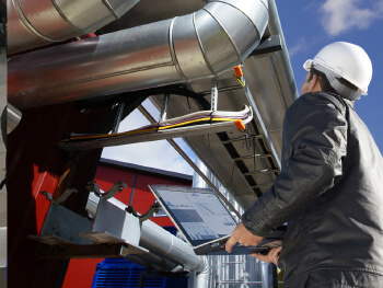 HVAC technician assessing an HVAC system