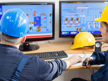 Two men reviewing a custom HVAC remote monitoring system